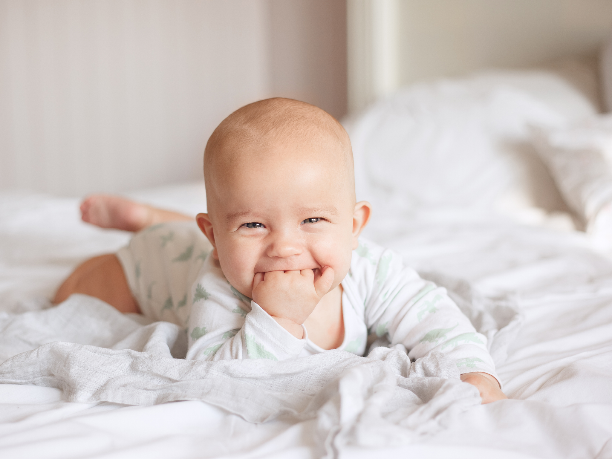 joyful baby boy on the bed