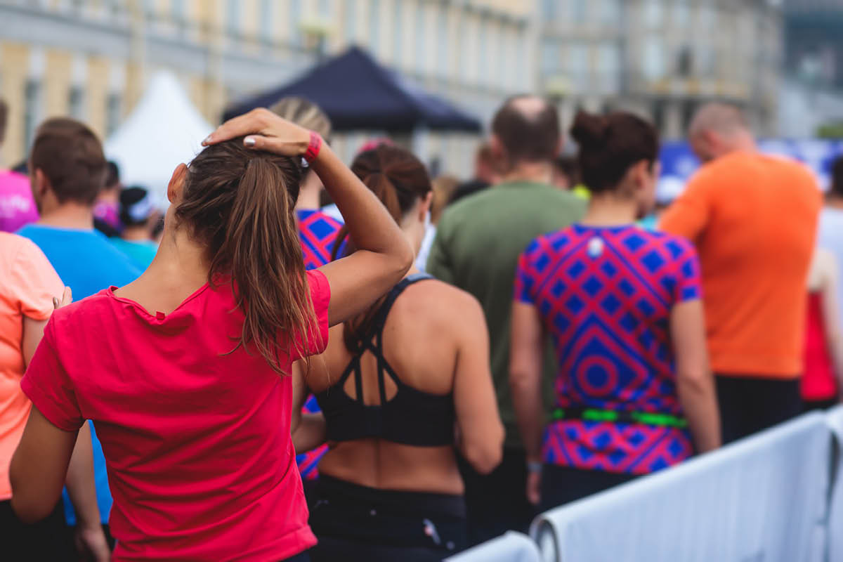 Marathon runners crowd, participants start running the half-marathon in the city streets, crowd of joggers in motion, group athletes outdoor training competition