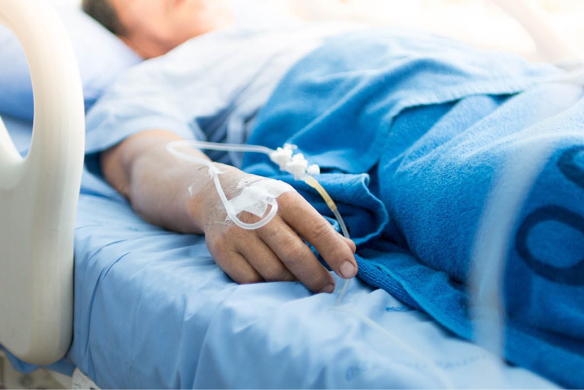 Focus on the hand of a patient in hospital ward