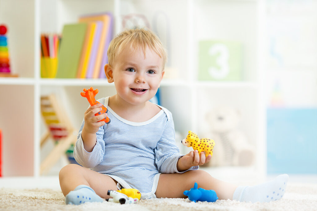 boy child playing with animal toys