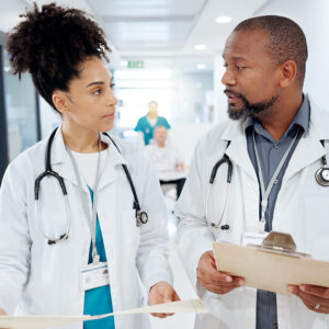 A medical student hands off a patient to a doctor.