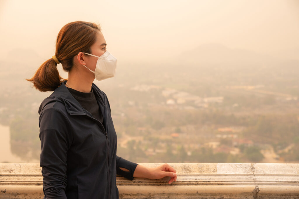 Asian woman wearing an N95 mask for protect bad air pollution.