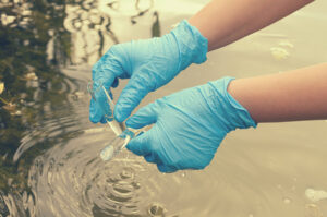 Taking a water test for analysis from a flood waters, looking for cholera.