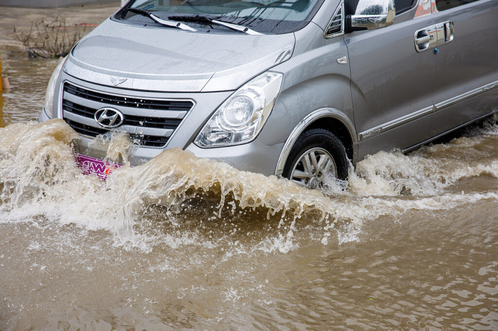 Car going through flooded streets in Puerto Rico after Hurricane Fiona.